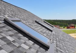 Attic skylight. Asphalt shingled house. Arlington Roofing construction with attic, roof, windows, skylights, and waterproofing.